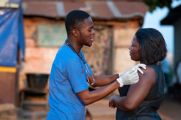 Médico de ajuda humanitária da África cuidando de paciente