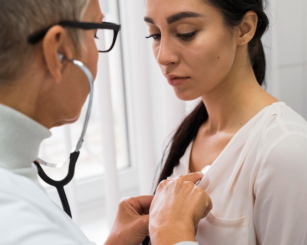 Médico usando um estetoscópio em um paciente