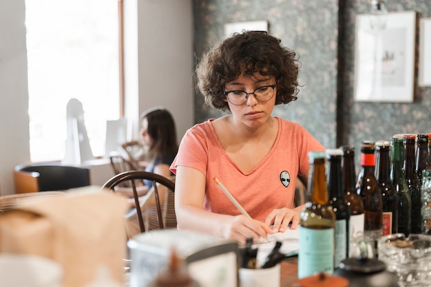 Menina adolescente, fazendo, dever casa, em, café, contador