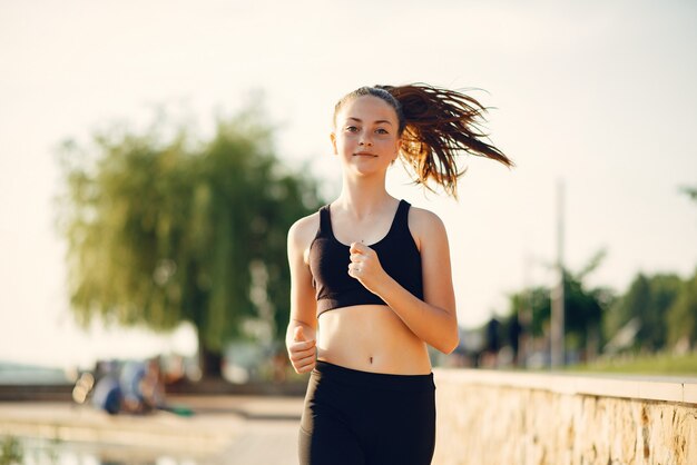 Menina bonita de esportes em um parque de verão