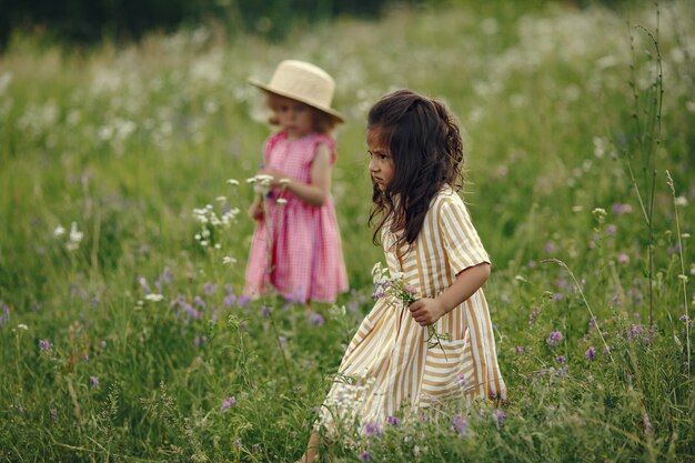 Menina bonitinha brincando em um campo de verão