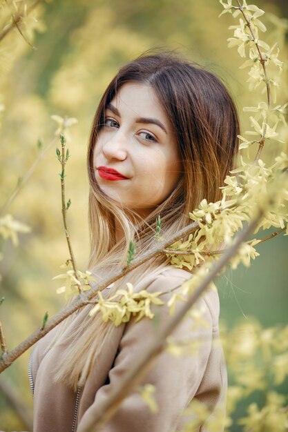 Menina elegante em um parque de primavera