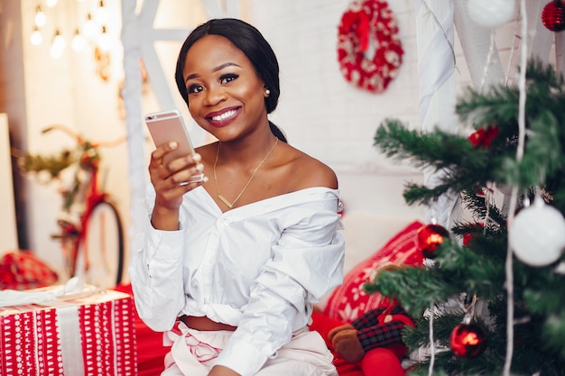 Menina negra elegante nas decorações de Natal