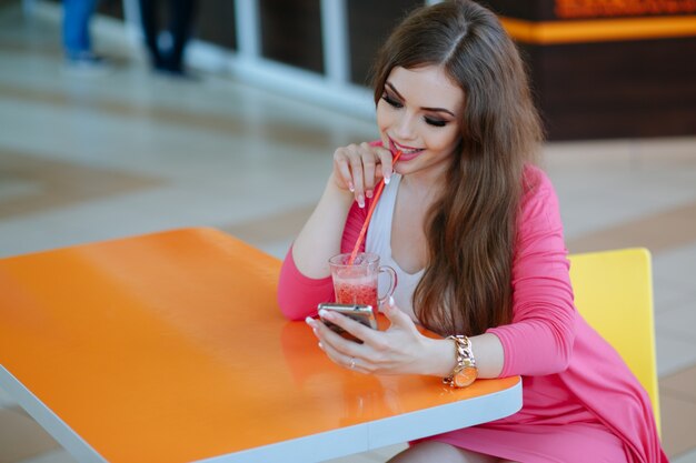 Menina que sorri ao olhar para ela de smartphones