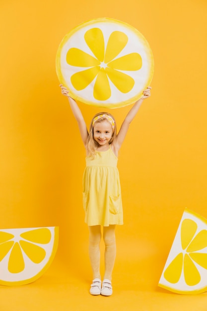 Foto grátis menina segurando decoração de fatia de limão