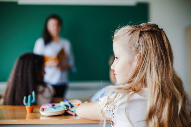 Foto grátis menina sentada na sala de aula