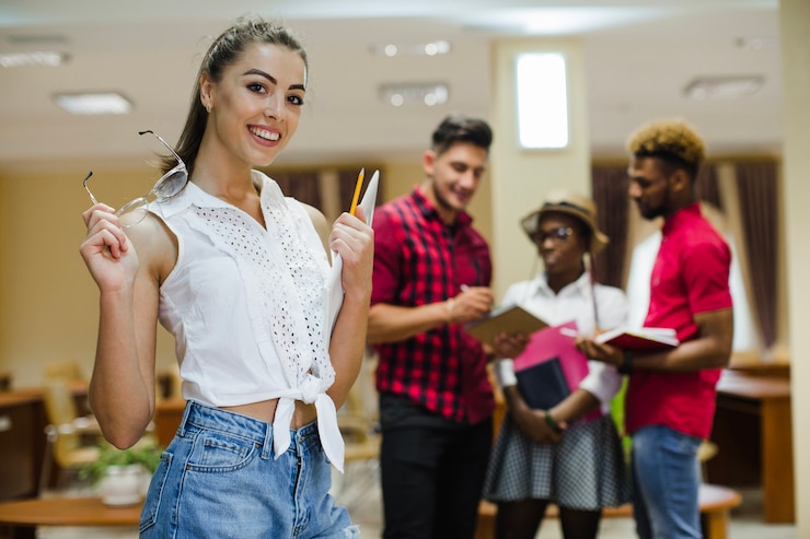 Foto grátis menina sorridente com óculos e notepad