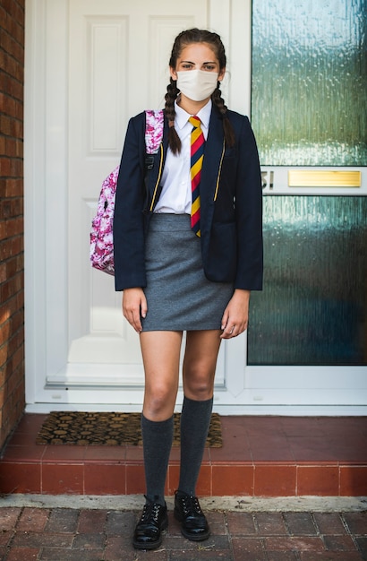 Foto grátis menina usando máscara e indo para a escola no novo normal