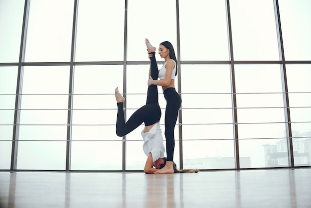 Meninas bonitas e elegantes fazendo yoga