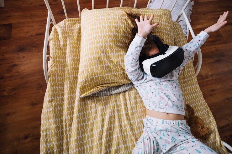Foto grátis menino brincalhão em óculos vr na cama