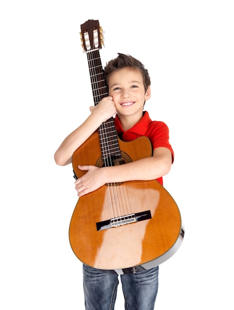 Foto grátis menino caucasiano sorridente segura o violão -