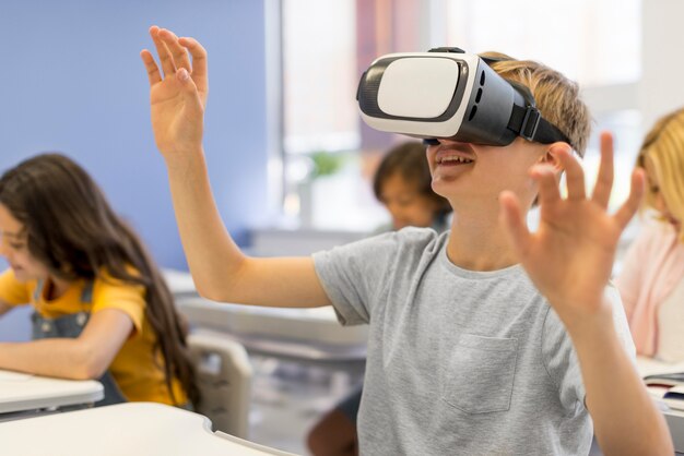 Menino com fone de ouvido de realidade virtual na escola