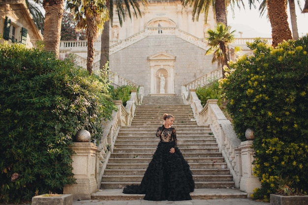 Moda mulher bonita em vestido preto de luxo ao ar livre