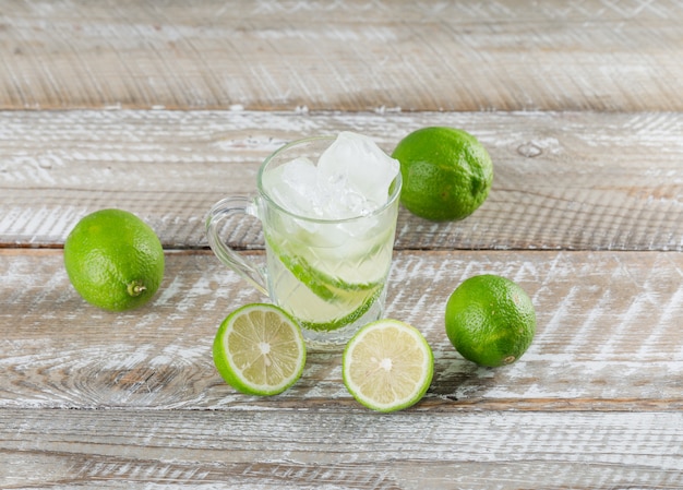 Foto grátis mojito gelado cocktail com cais em um copo na superfície de madeira, vista de alto ângulo.