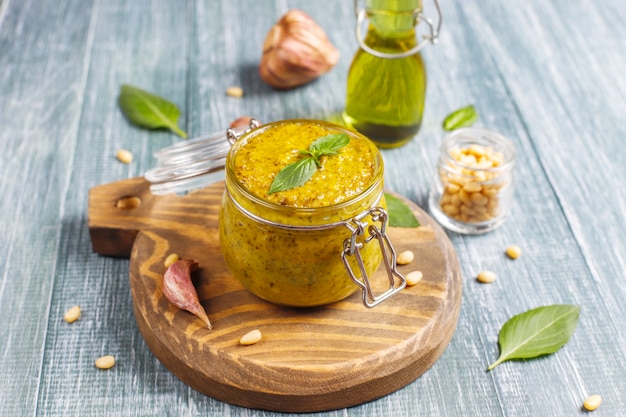 Molho de pesto de manjericão italiano com ingredientes culinários para cozinhar.