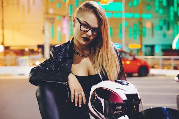 Motociclista de mulher retrato curtindo a vida noturna da cidade