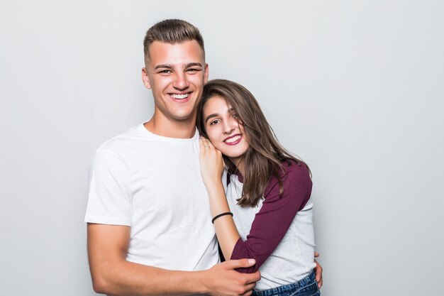 Muito jovem e bonito casal sorridente, menino e menina, isolados no branco