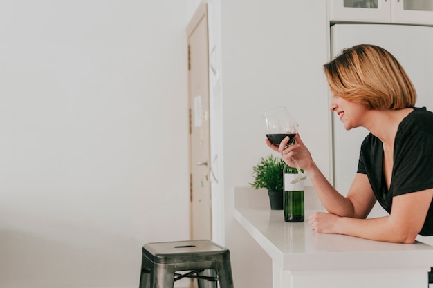 Mulher alegre com um copo de vinho