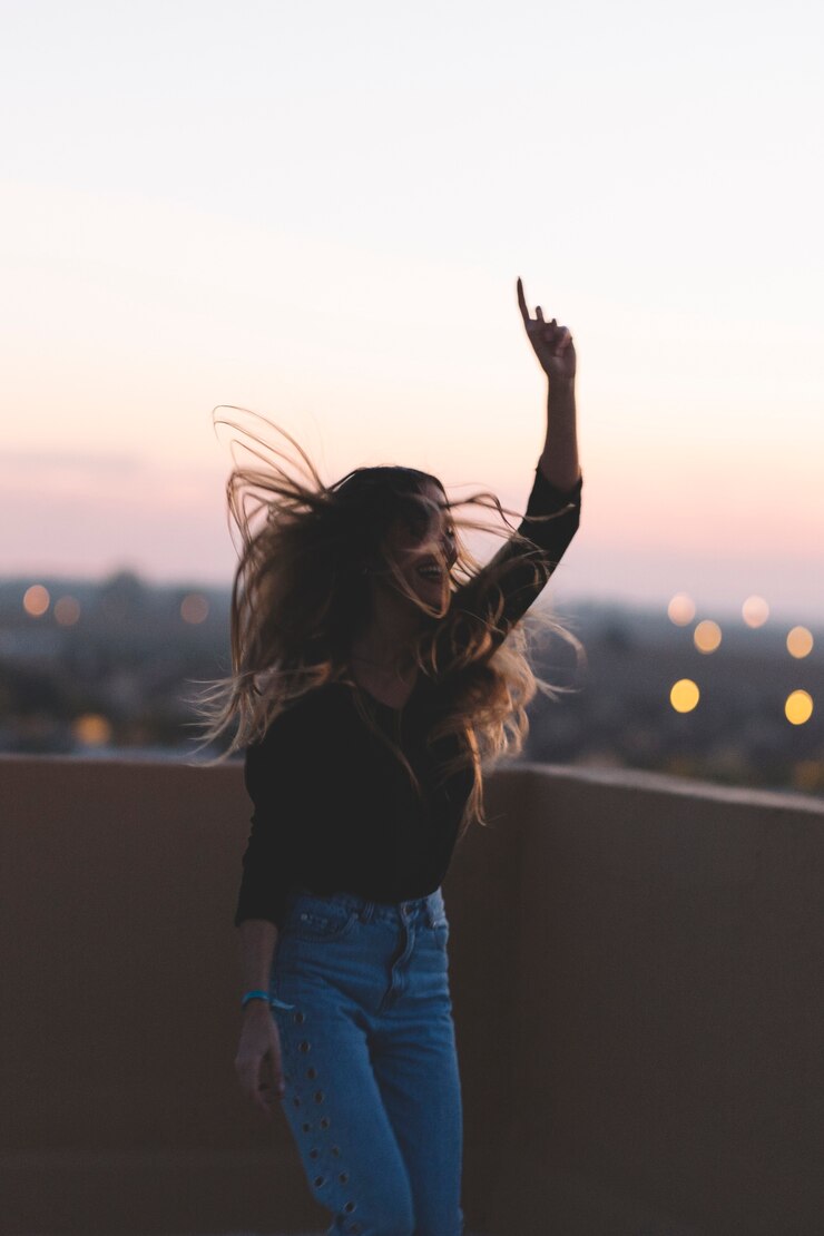 Foto grátis mulher alegre dançando no telhado