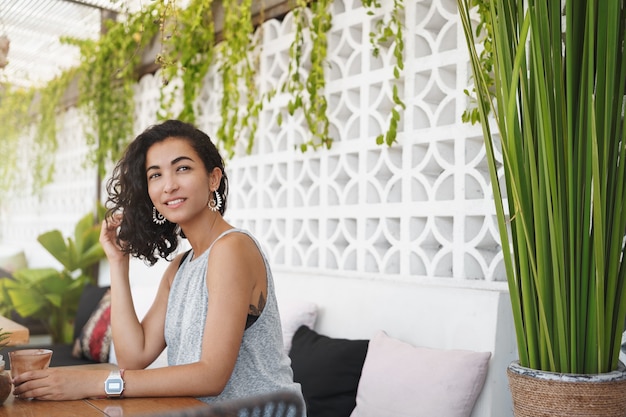 Foto grátis mulher alegre sentada na esplanada do café