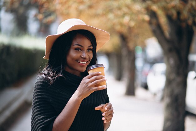 Mulher americana africana, em, chapéu, café bebendo