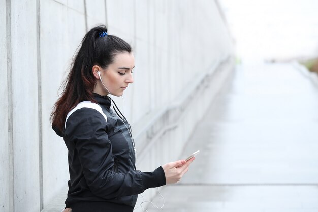 Mulher atleta olhando seu smartphone