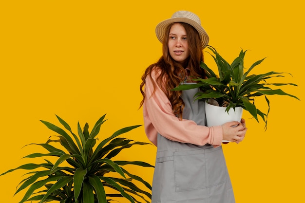 Mulher bonita posando com vasos de plantas