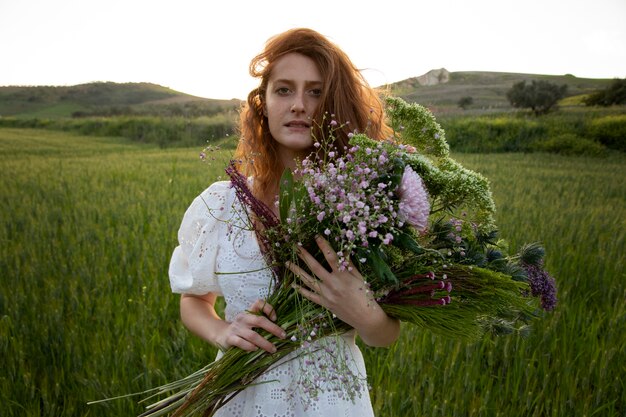 Mulher com buquê de flores plano médio