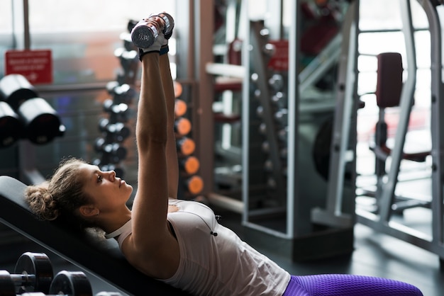 Mulher, com, dumbbells, mentindo, ligado, banco