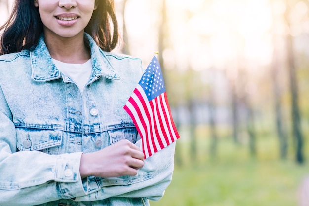 Mulher, com, pequeno, bandeira americana, ao ar livre