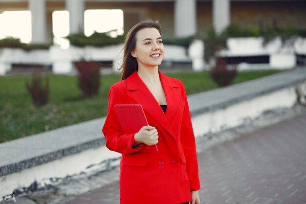 Mulher de casaco vermelho usando um tablet