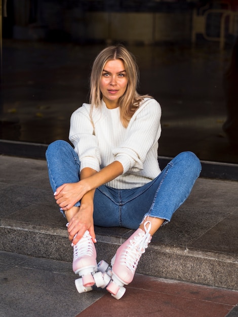 Foto grátis mulher de jeans posando com patins na