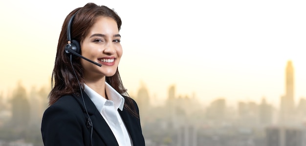 Mulher de negócios atraente e fones de ouvido estão sorrindo enquanto trabalha. assistente de atendimento ao cliente trabalhando