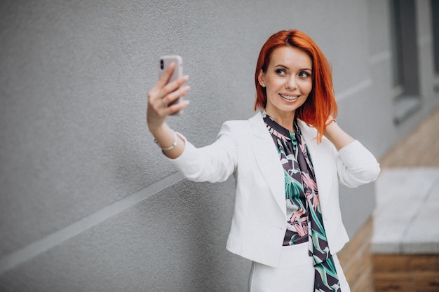 Mulher de negócios elegante terno branco, falando ao telefone