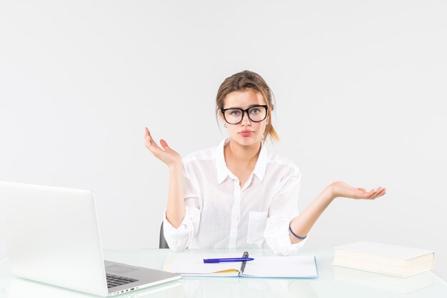 Mulher de negócios jovem bonita confusa na recepção com um laptop isolado no fundo branco