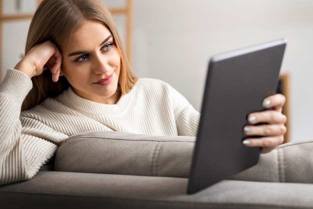 Mulher de tiro médio lendo revista digital