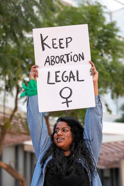Mulher de tiro médio protestando ao ar livre