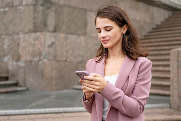 Foto grátis mulher de tiro médio segurando o telefone