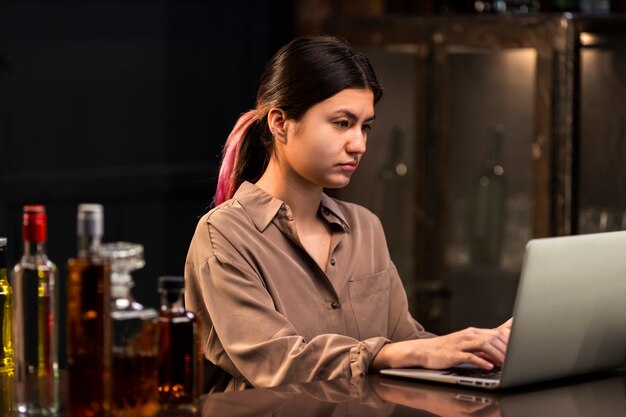 Mulher de tiro médio trabalhando com laptop