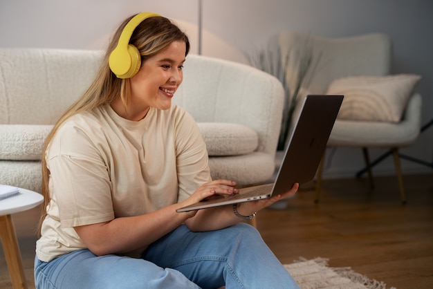 Foto grátis mulher de vista lateral fazendo videochamadas com laptop