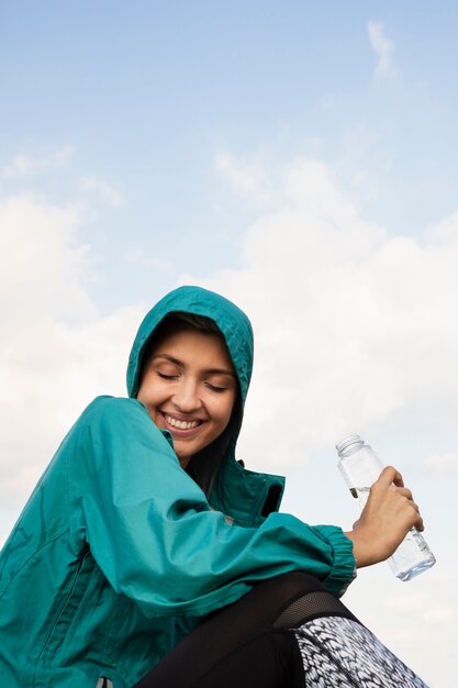 Mulher desportiva segurando uma garrafa de água