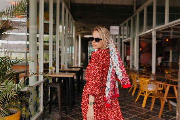 Mulher elegante e moderna com cabelo loiro e vestido vermelho de verão