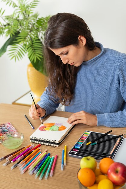 Foto grátis mulher em casa desenhando