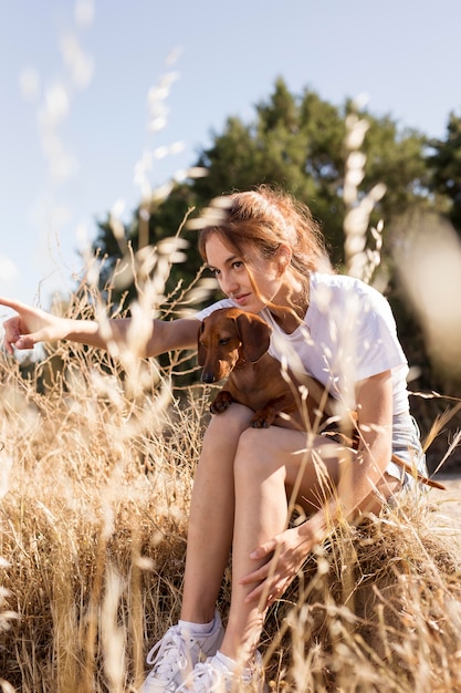 Mulher em cena completa segurando um cachorro fofo