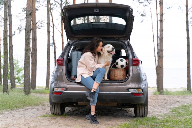 Foto grátis mulher em cena completa segurando um cachorro