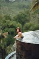 Foto grátis mulher em uma piscina em uma vista da selva