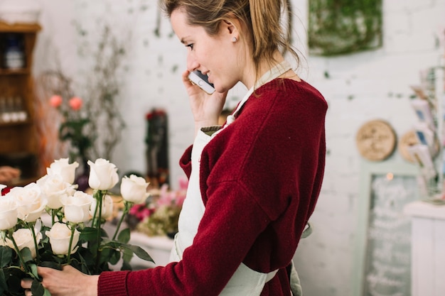 Mulher falando no telefone na loja floral