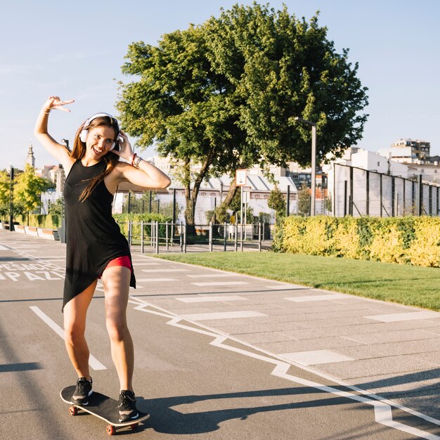 Mulher feliz andando de skate na rua