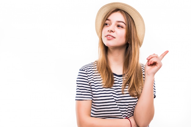 Mulher feliz, apontando para o lado sobre uma parede branca