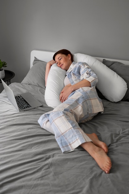 Foto grátis mulher grávida de alto ângulo relaxando em casa